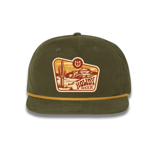 Howdy Beer green rope hat with desert landscape scene